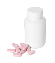 Bottle and pile of vitamin pills isolated on white