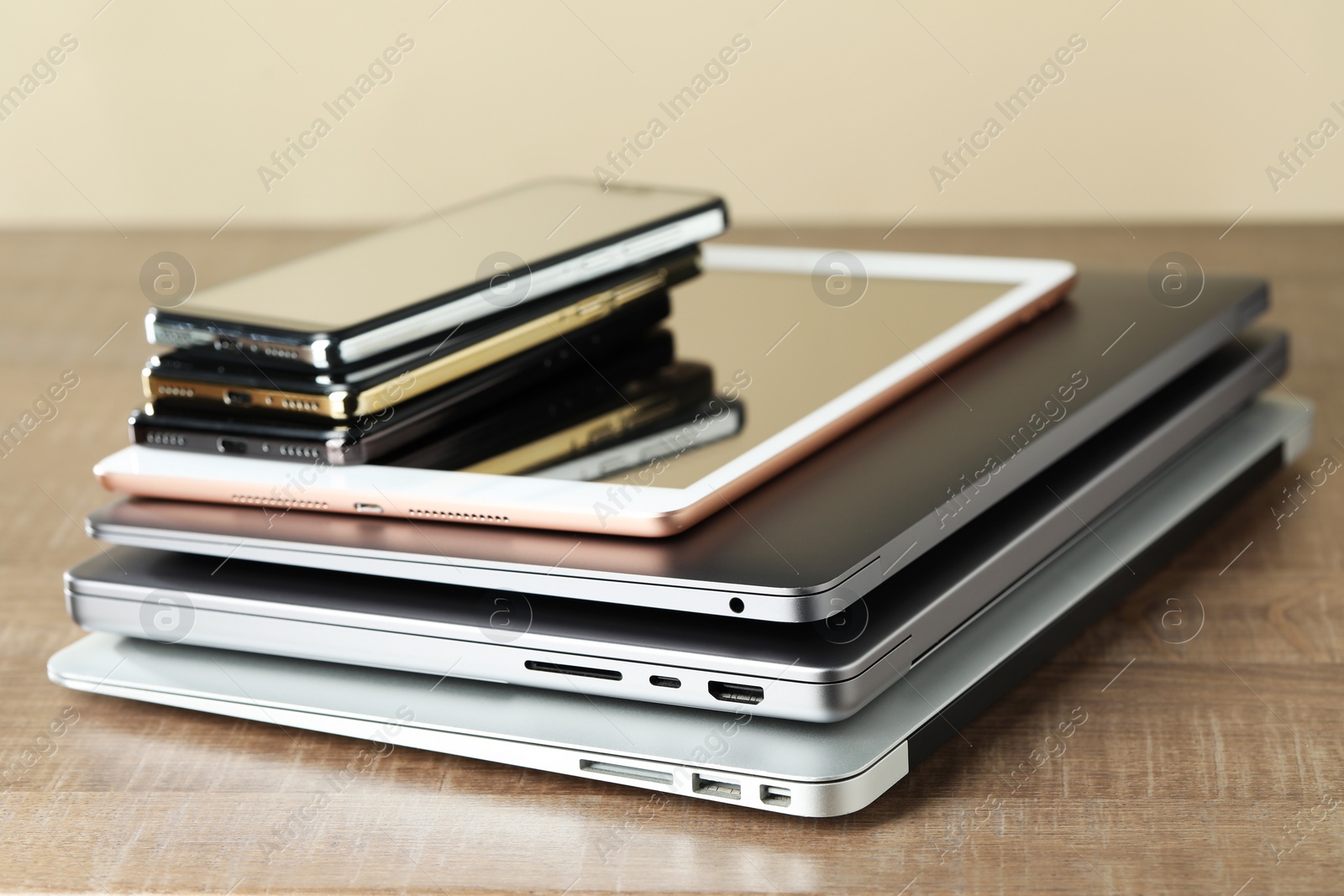 Photo of Stack of electronic devices on wooden table