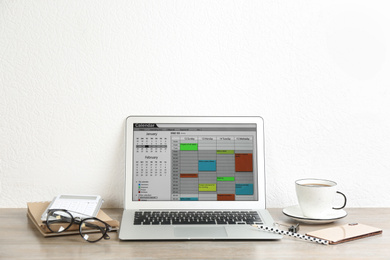Modern laptop with calendar app in office