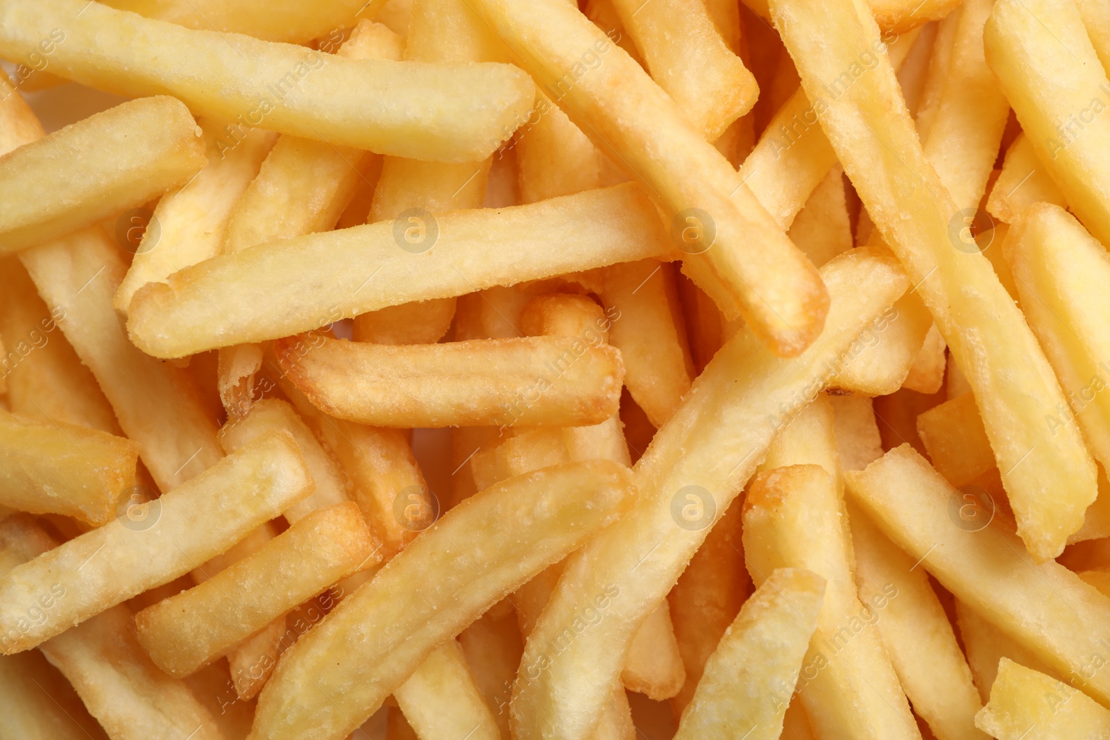 Photo of Many delicious French fry pieces as background