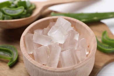 Aloe vera gel and slices of plant on table, closeup