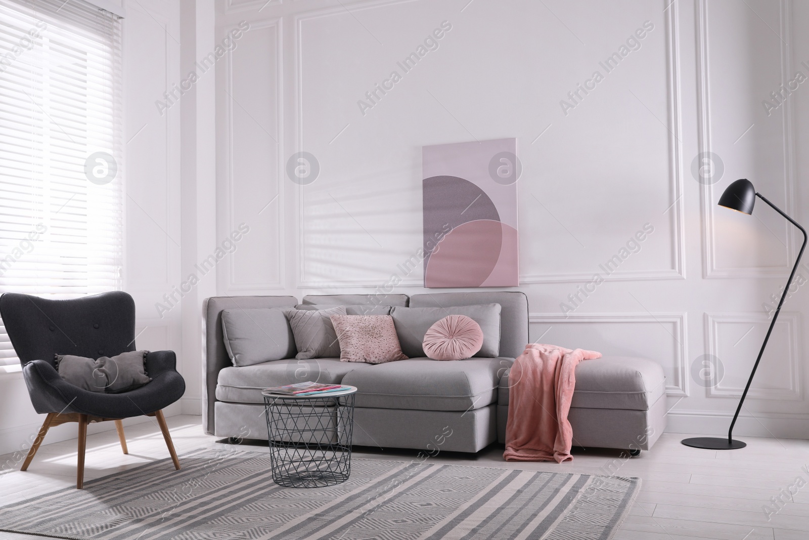 Photo of Cozy living room interior with comfortable grey sofa and armchair