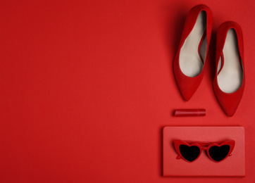 Flat lay composition with stylish women's shoes on red background. Space for text