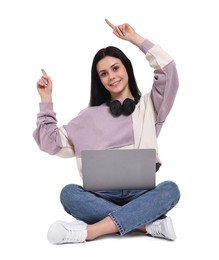 Photo of Smiling student with laptop pointing at something on white background