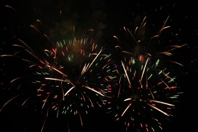 Photo of Beautiful fireworks lighting up night sky outdoors