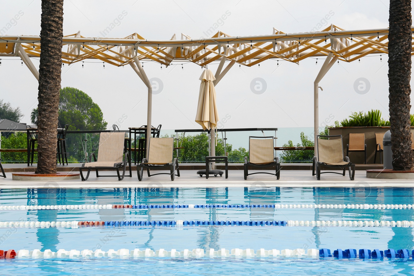 Photo of Swimming pool and sunbeds at luxury resort