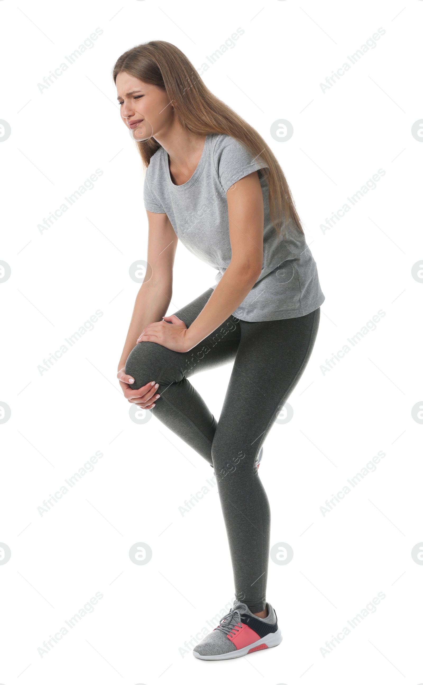 Photo of Full length portrait of sportswoman having knee problems on white background