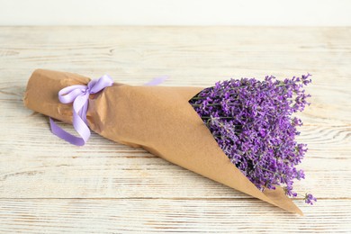 Photo of Beautiful lavender bouquet on white wooden table