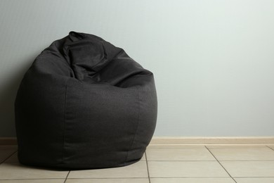 Photo of Bean bag chair near light grey wall in room. Space for text