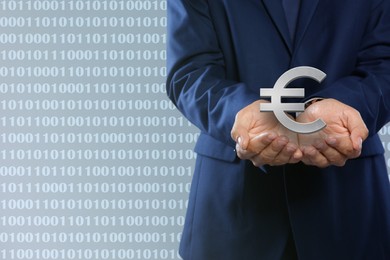 Man demonstrating virtual euro sign on light background, closeup. Space for text