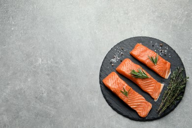 Photo of Fresh raw salmon and ingredients for marinade on grey, top view. Space for text