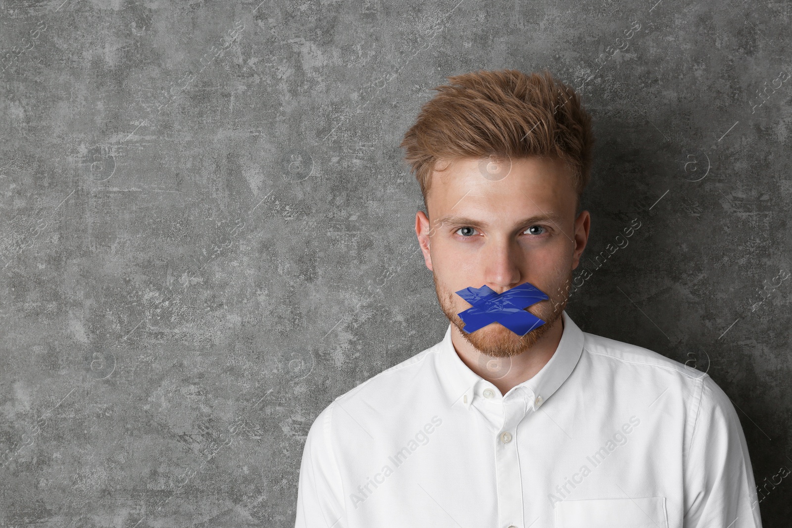 Image of Man with taped mouth on grey background, space for text. Speech censorship