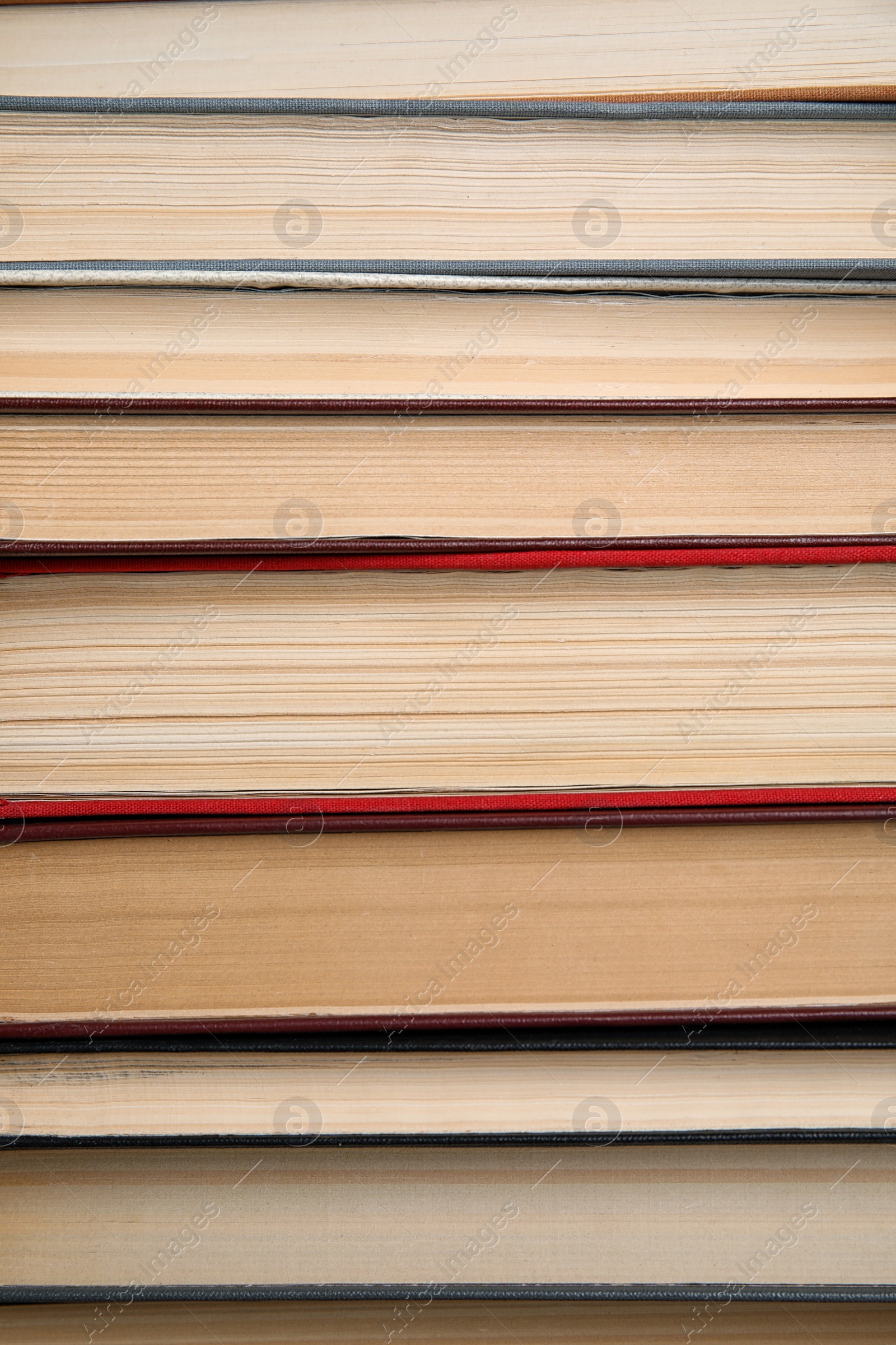 Photo of Stack of hardcover books as background, closeup