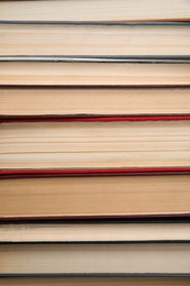 Stack of hardcover books as background, closeup