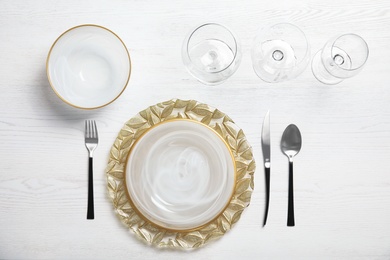 Elegant table setting on light background, top view