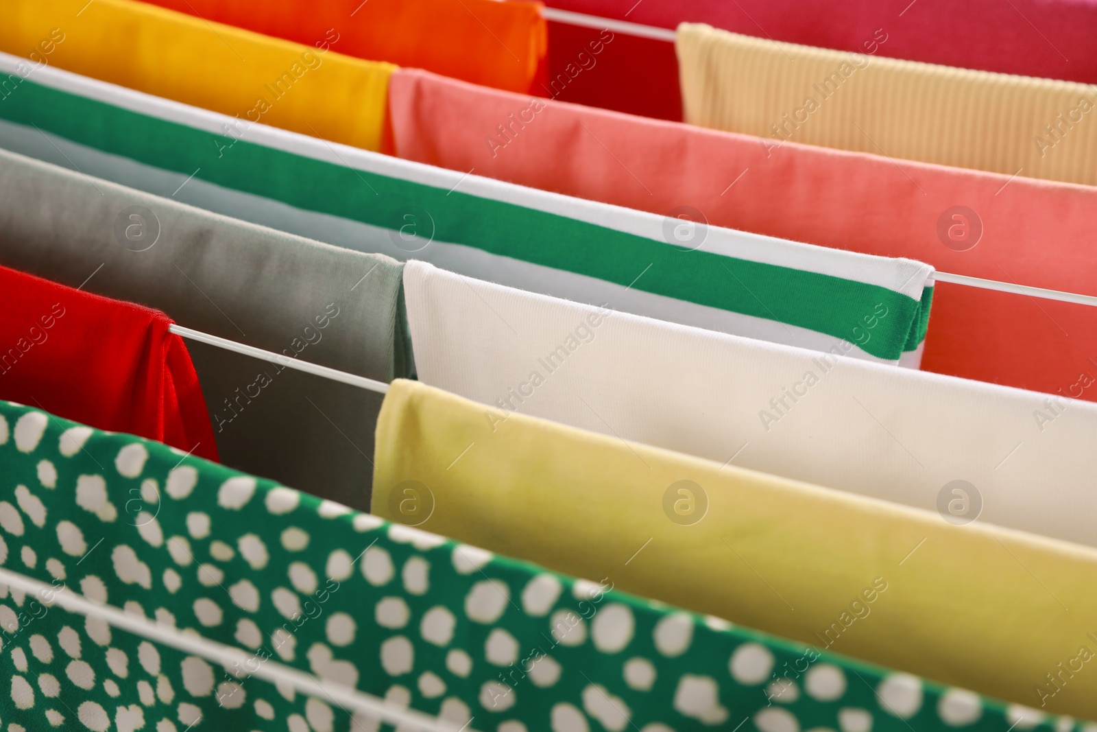 Photo of Different apparel drying on clothes airer, closeup