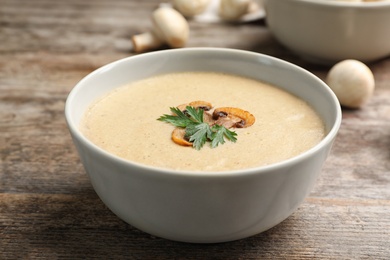 Bowl of fresh homemade mushroom soup on wooden table