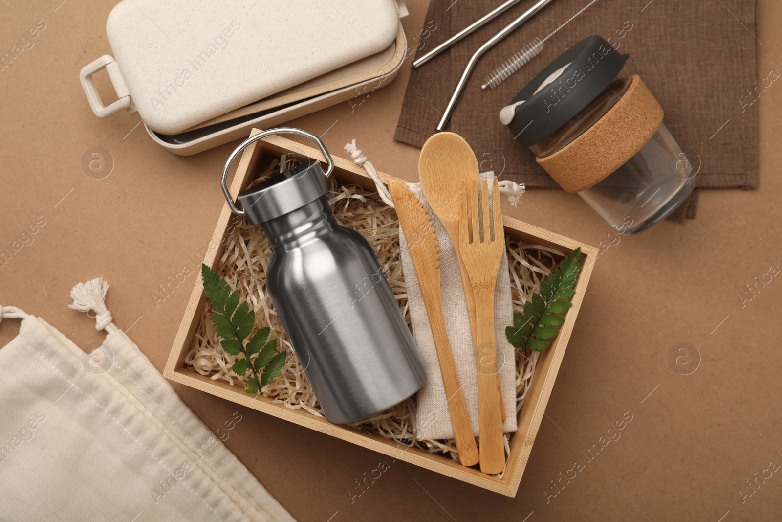 Photo of Flat lay composition with eco friendly products on brown background