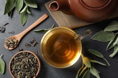 Flat lay composition with aromatic sage tea on black table