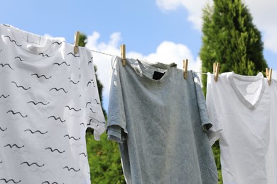 Photo of Washing line with clean clothes outdoors. Drying laundry outside