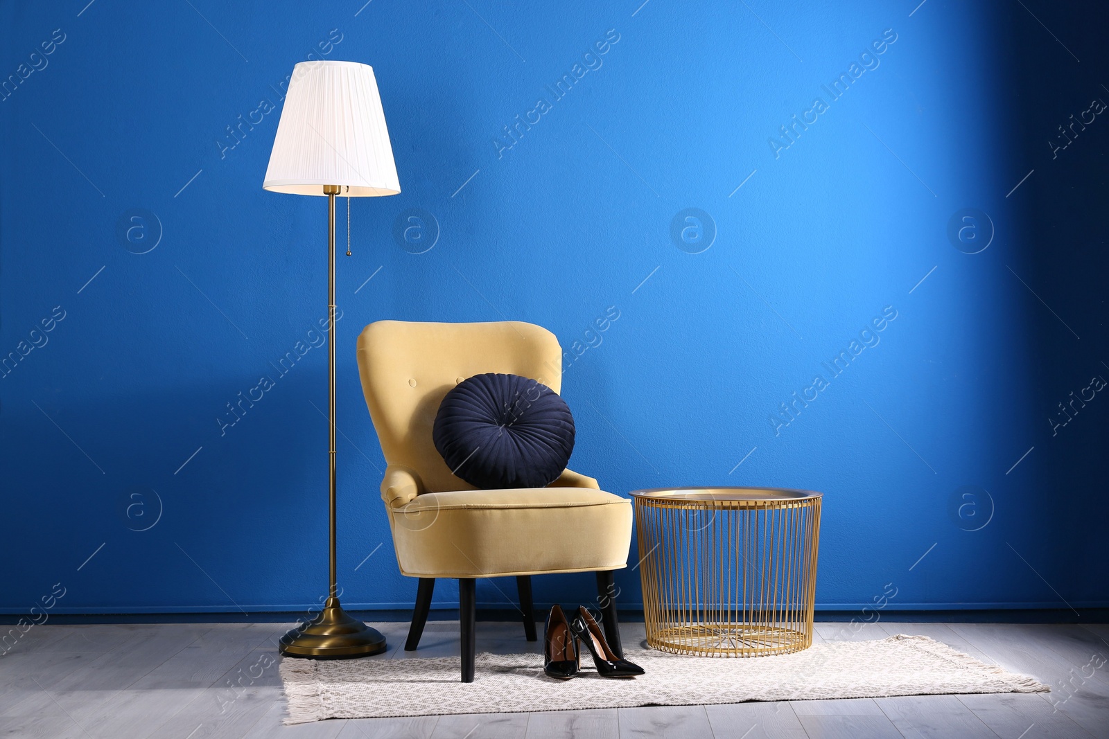 Photo of Comfortable armchair with cushion in stylish room interior