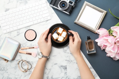 Photo of Woman with coffee, accessories and computer keyboard on marble background, flat lay. Beauty blogger