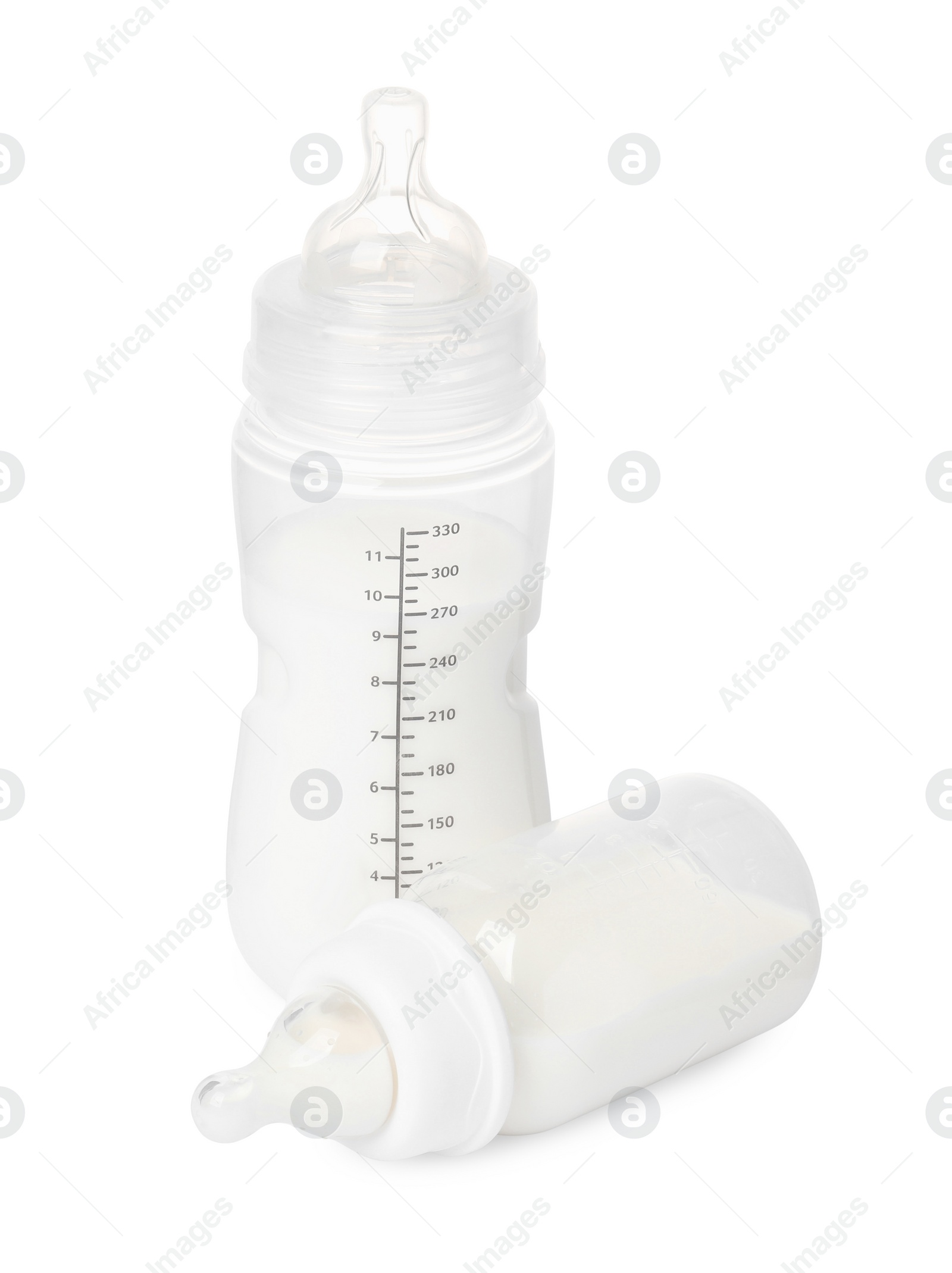 Photo of Two feeding bottles with infant formula on white background