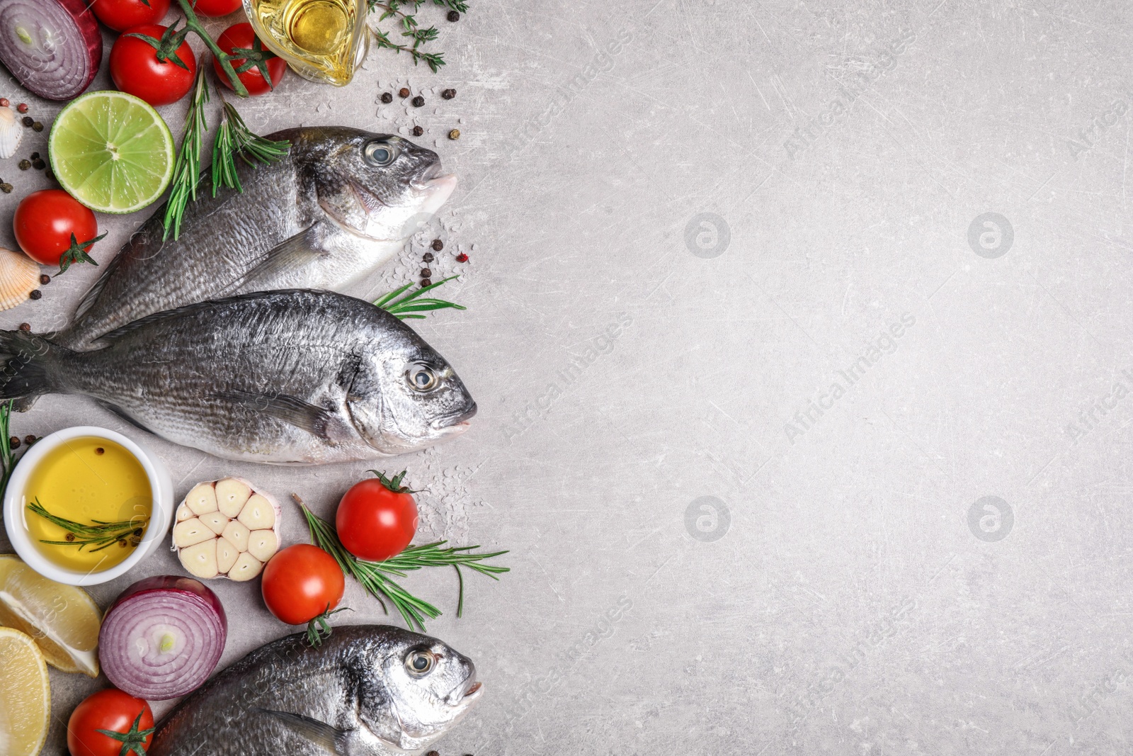 Photo of Flat lay composition with dorada fish on light grey table, space for text