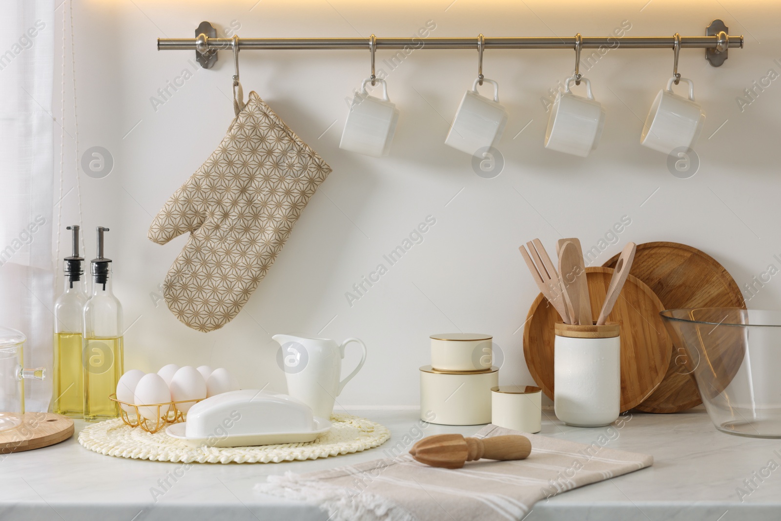 Photo of Set of different utensils and dishes on countertop in kitchen