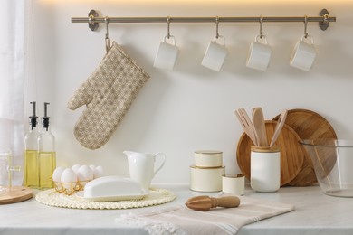 Photo of Set of different utensils and dishes on countertop in kitchen