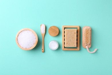 Jar of cream and body care products on turquoise background, flat lay