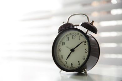 Alarm clock on windowsill, space for text. Morning time