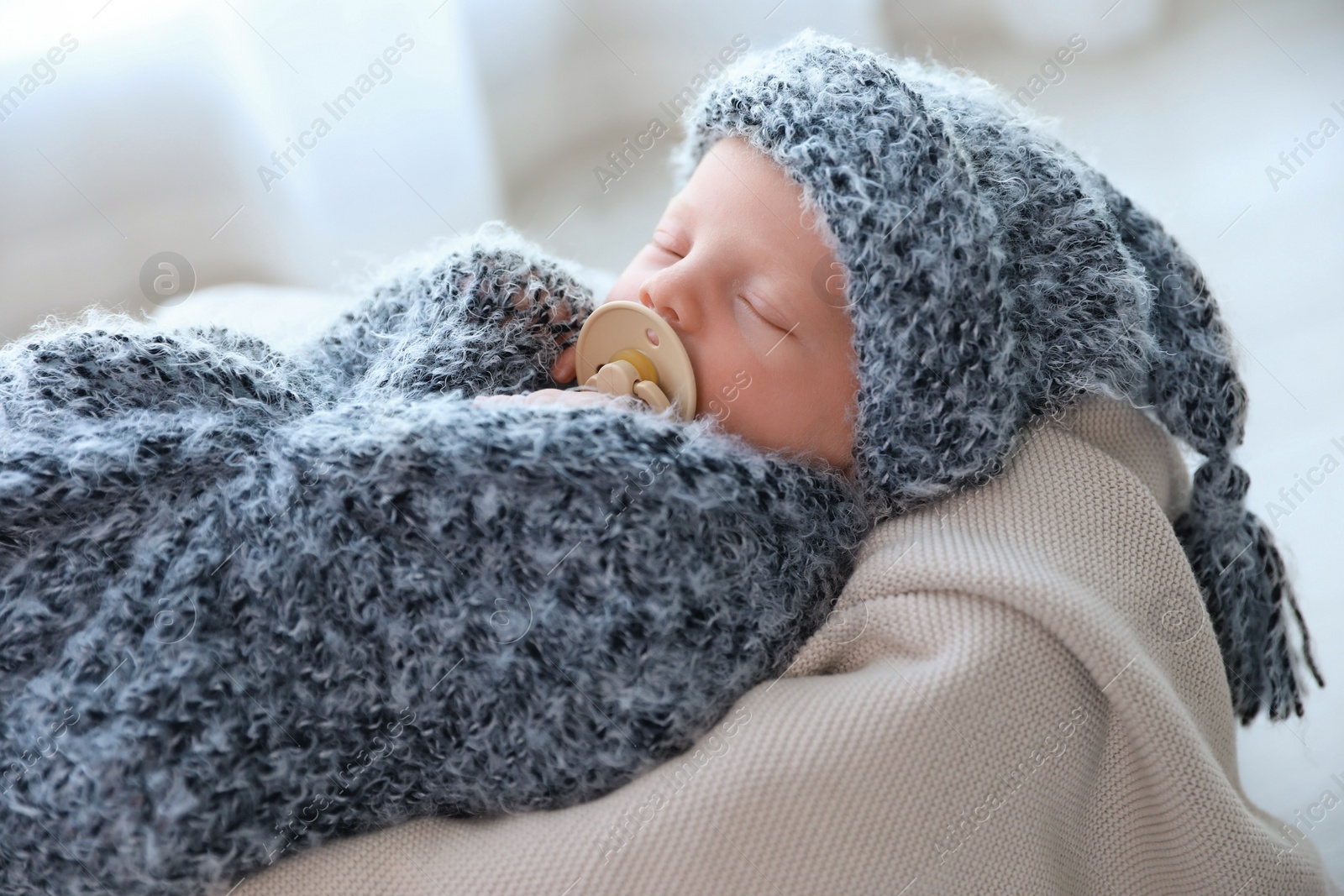 Photo of Cute newborn baby sleeping on plaid at home