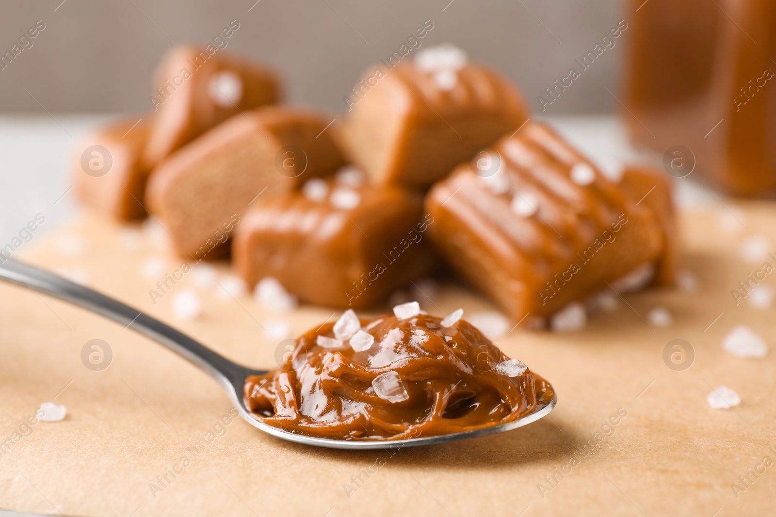 Photo of Salted caramel in spoon on parchment, closeup