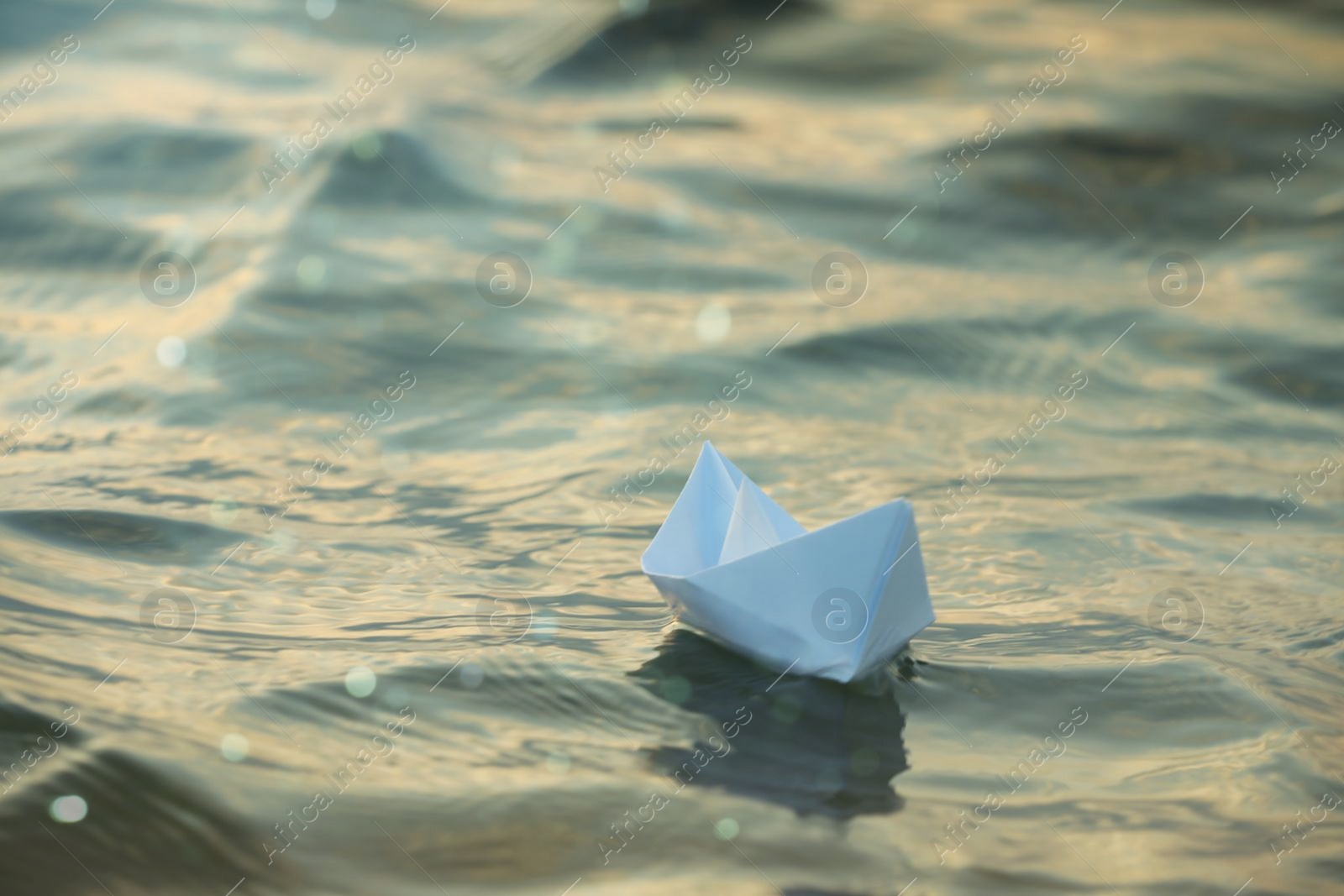 Photo of Paper boat floating on water outdoors. Space for text