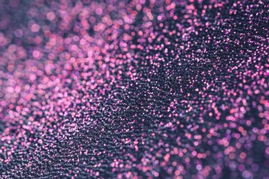 Photo of Pink glitter with bokeh effect on dark background