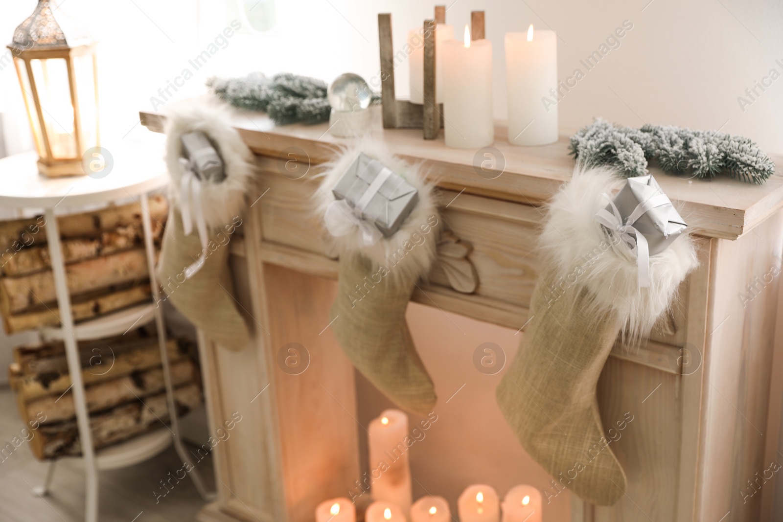 Photo of Fireplace decorated with Santa stockings indoors. Christmas decor idea