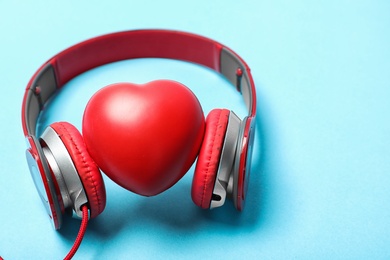 Photo of Composition with heart, headphones and space for text on color background