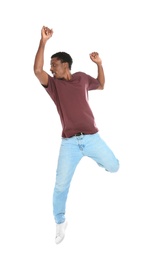 Full length portrait of African-American man jumping on white background