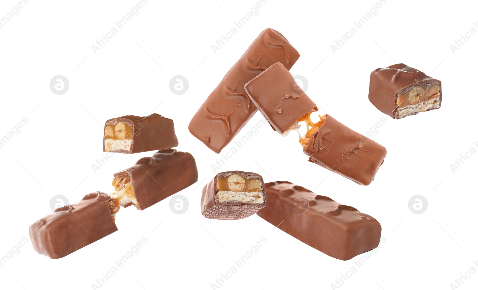 Image of Whole and broken chocolate bars with caramel, nuts and nougat falling on white background