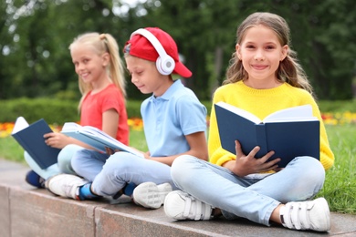 Image of Group of kids reading books on street