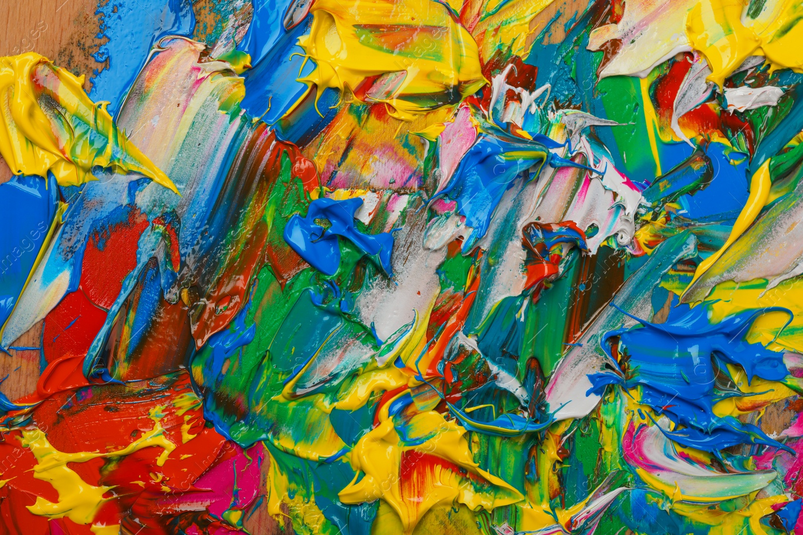 Photo of Abstract colorful acrylic paint as background, top view