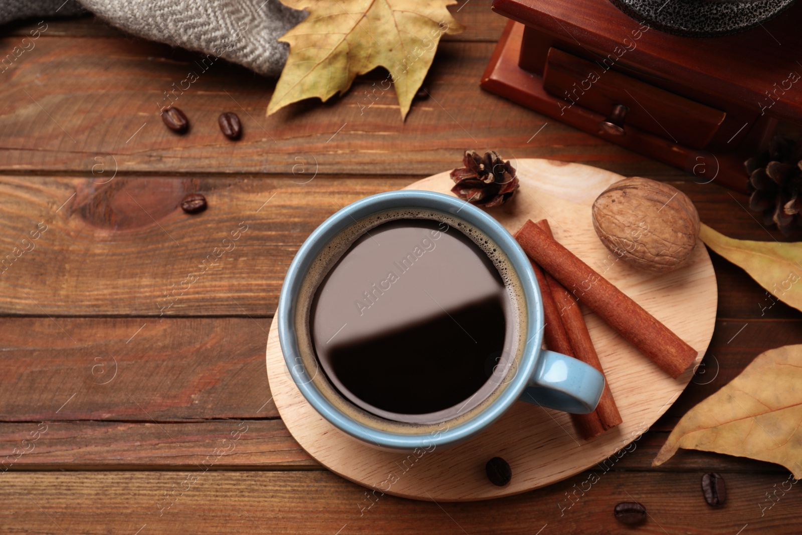 Photo of Flat lay composition with cup of hot drink on wooden table. Cozy autumn atmosphere