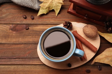 Flat lay composition with cup of hot drink on wooden table. Cozy autumn atmosphere