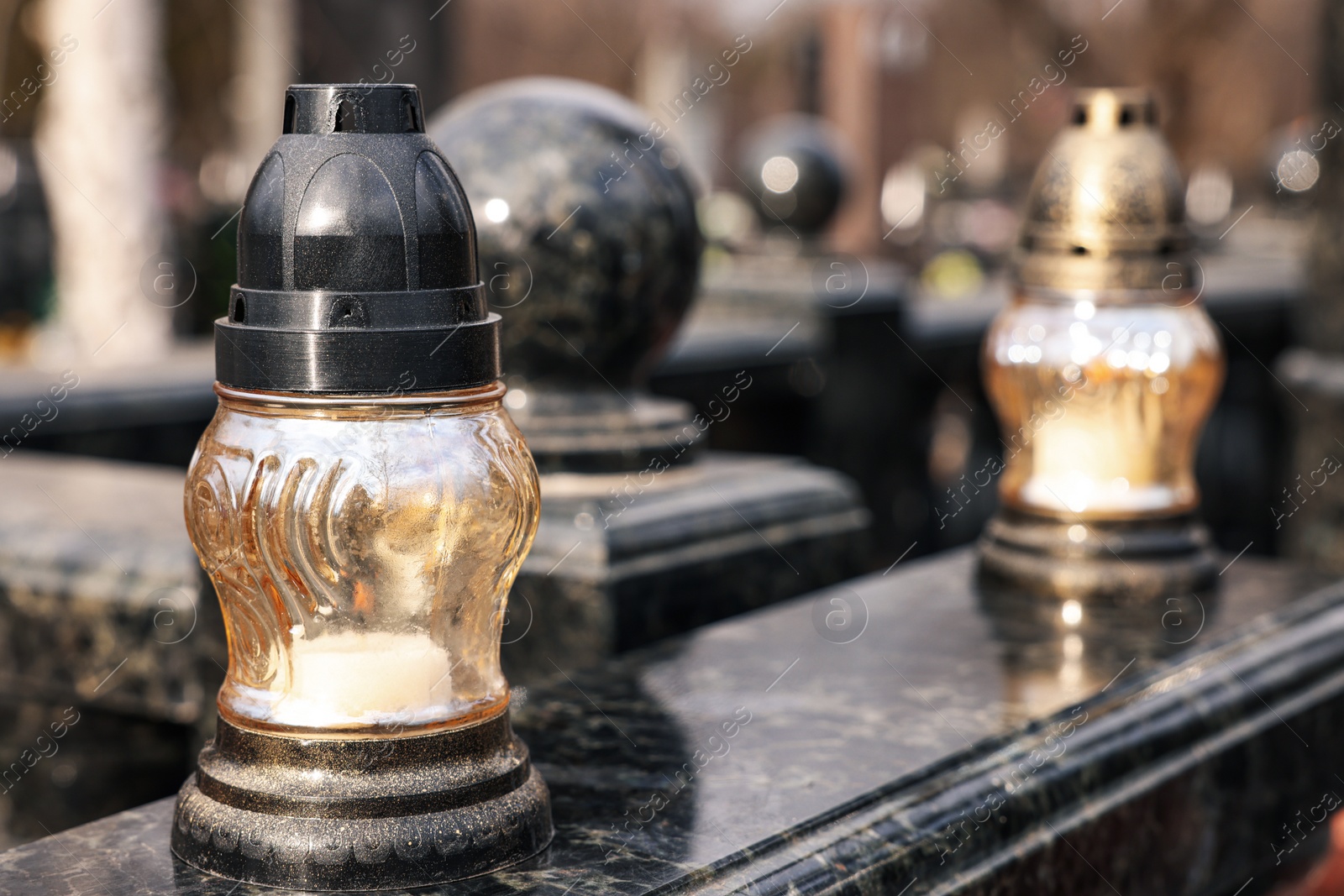 Photo of Grave lantern with candle on granite surface at cemetery, space for text