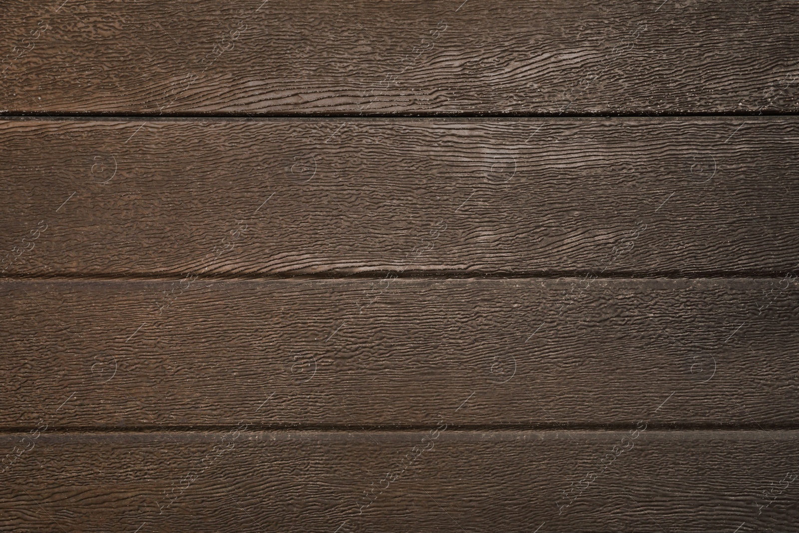 Photo of Texture of dark brown wooden surface as background