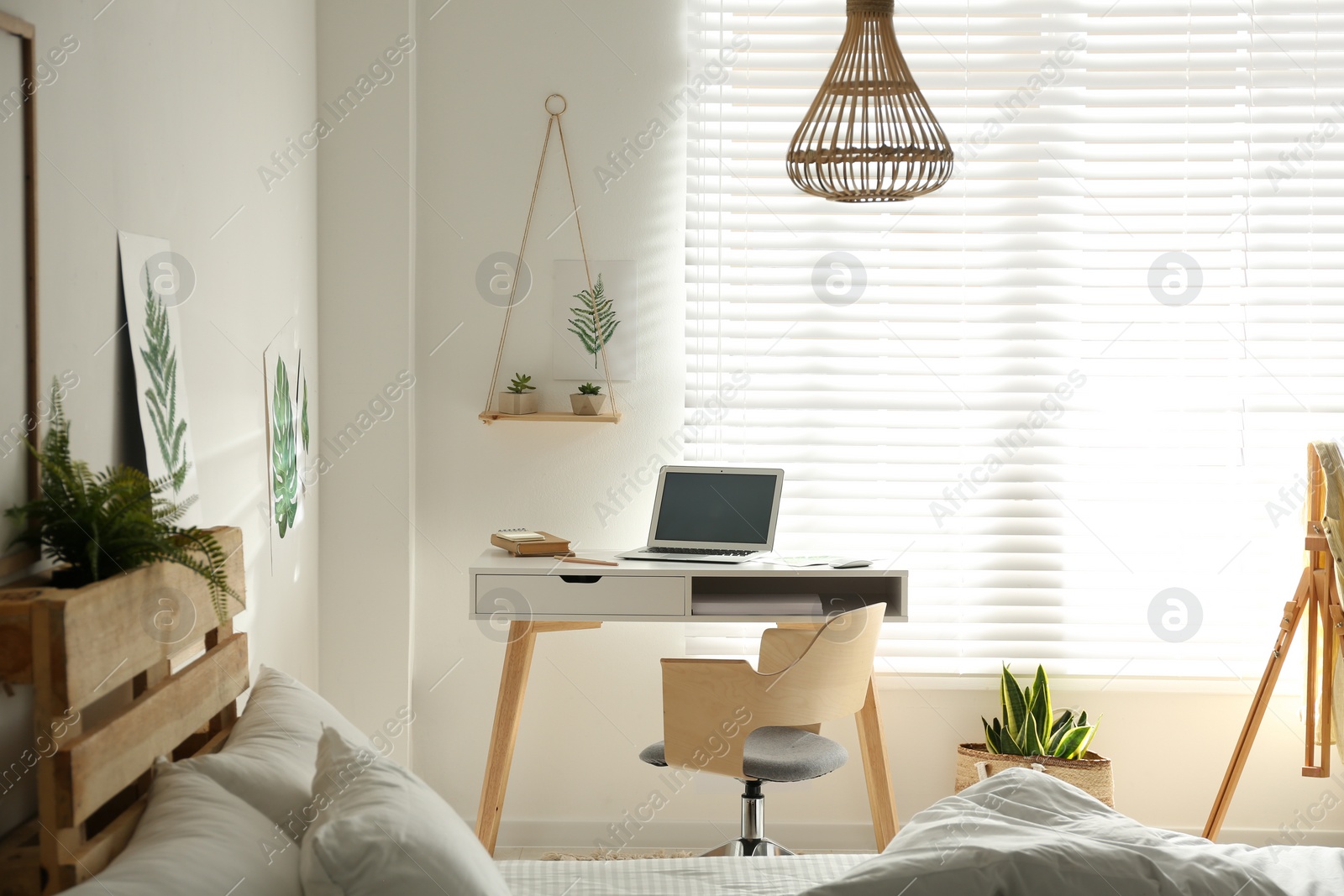 Photo of Stylish room interior with workplace near window