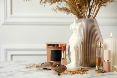 Photo of Beautiful Venus De Milo candle on white marble table, space for text. Stylish decor