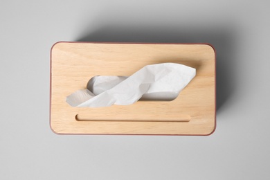 Photo of Holder with paper tissues on light grey background, top view