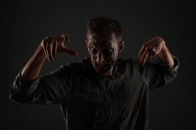 Scary zombie on dark background. Halloween monster